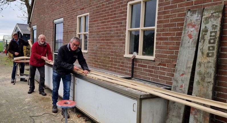 Klaas, Albert en Gienus druk bezig met het maken van de langste midwinterhoorn van Drenthe